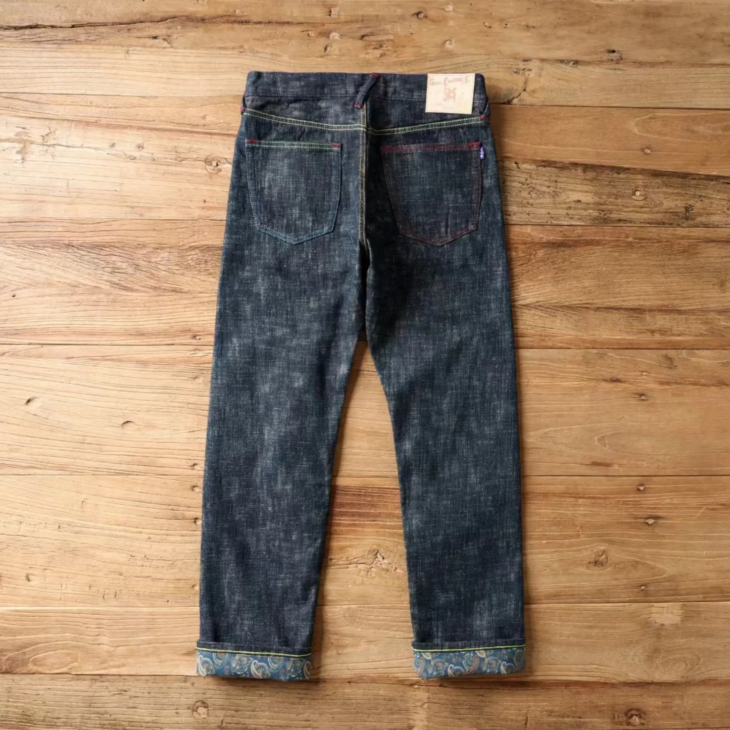 Pair of blue jeans on a wooden surface