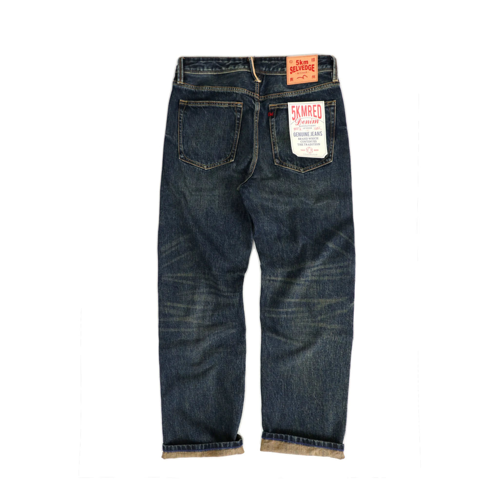 Blue jeans with a brand label on a white background