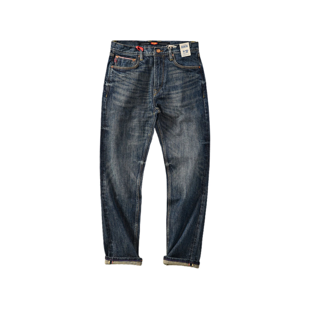 Blue jeans with a tag on a white background