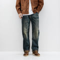Person wearing a brown jacket, white shirt, blue jeans, and brown shoes against a white background