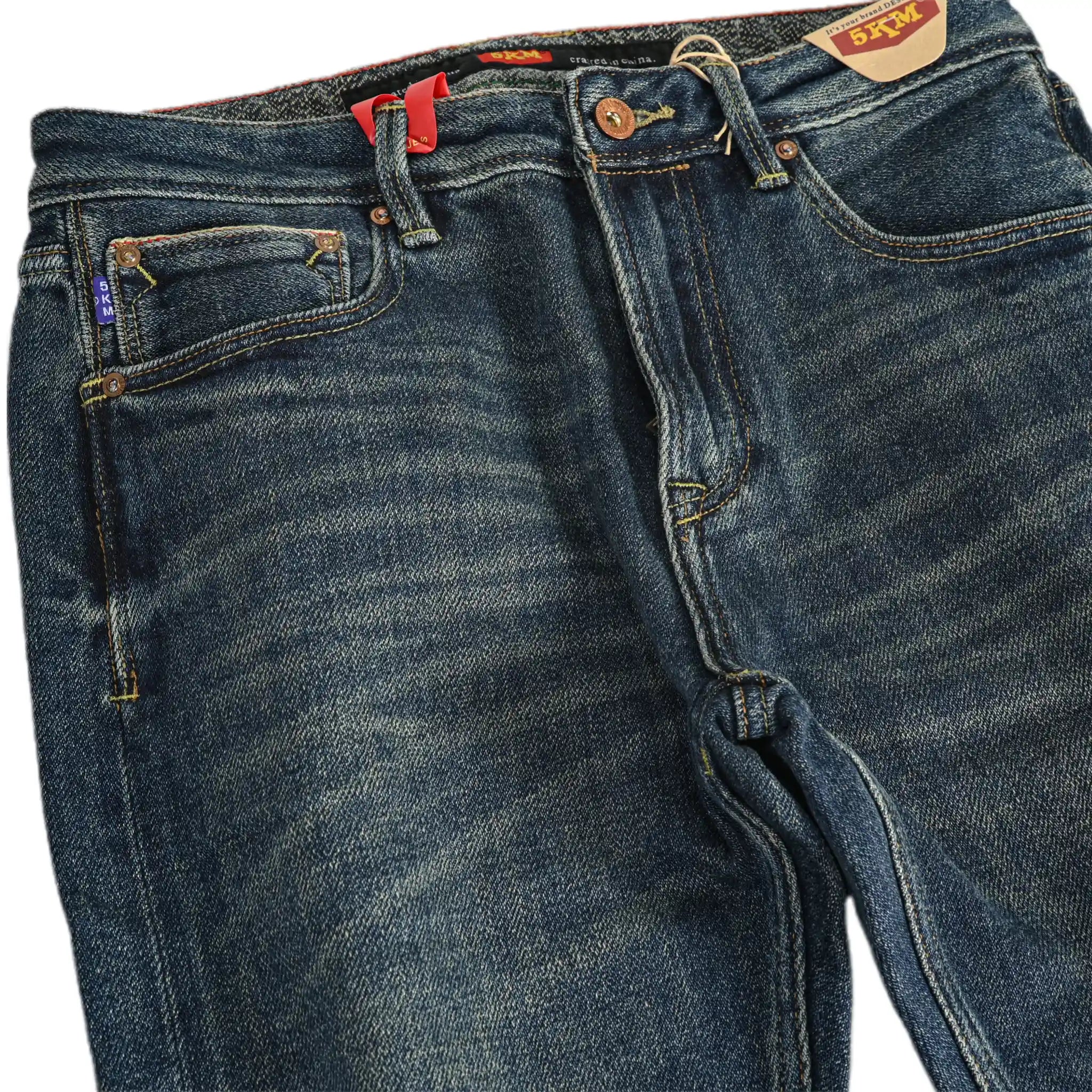Pair of blue jeans with brand labels on a white background
