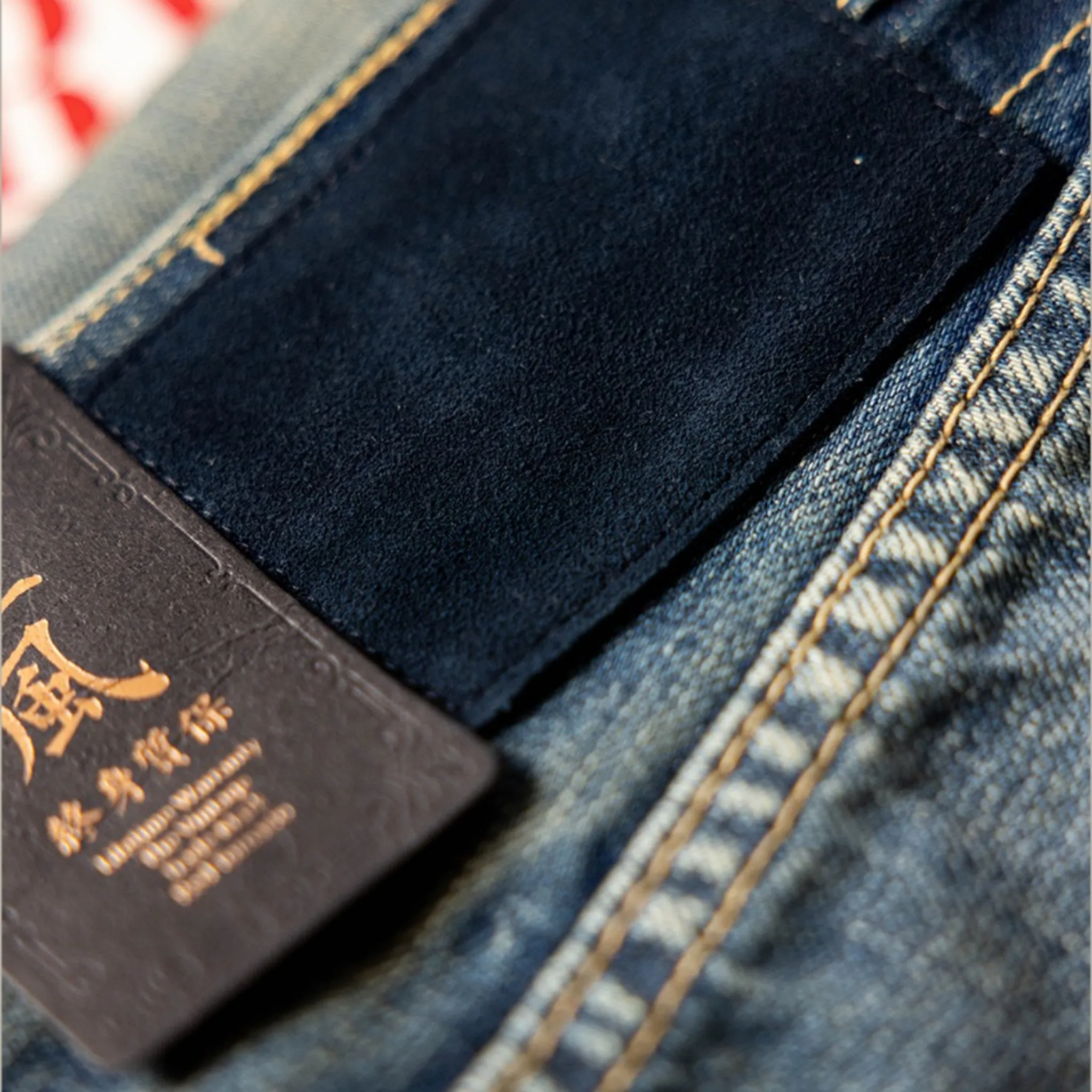 Close-up of a denim fabric with a brand label.