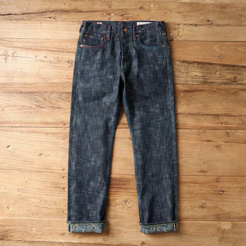 Pair of blue jeans on a wooden surface