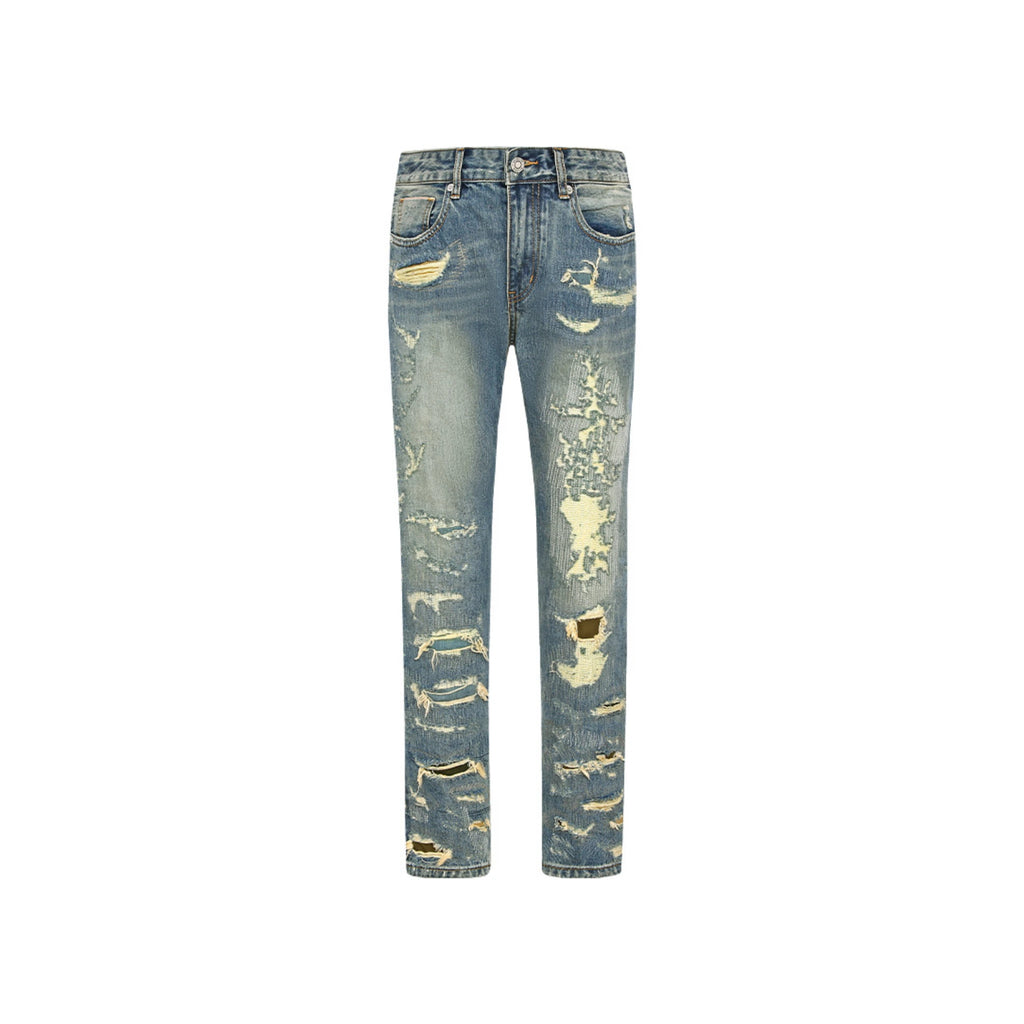 Distressed blue jeans on a white background