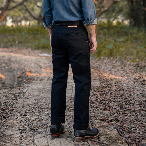 Rear view of model wearing 14.5oz Double Dyed Straight Fit Black Selvedge Chinos